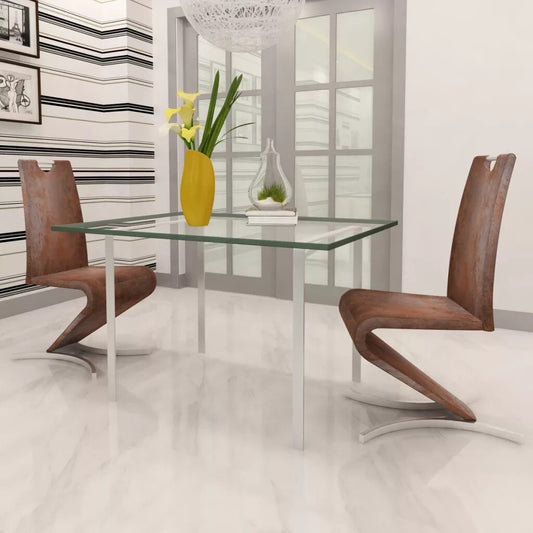 Chaise design en cuir poncé marron et pieds en double arc métallique