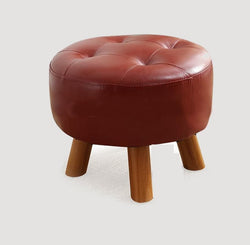 Tabouret scandinave bas en cuir avec assise ronde rembourrée et pieds en bois